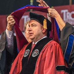 Graduate student at commencement ceremony.