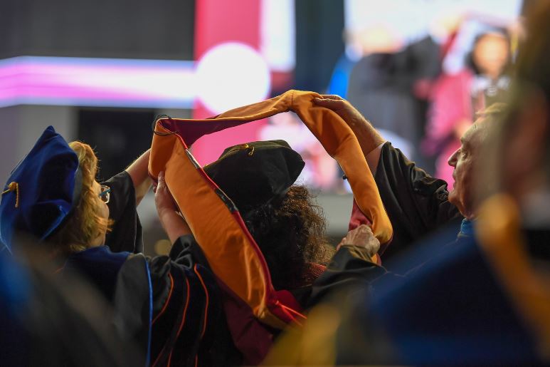 Graduate getting a hood at commencement