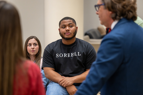 TROY student listening to a professor speak. 