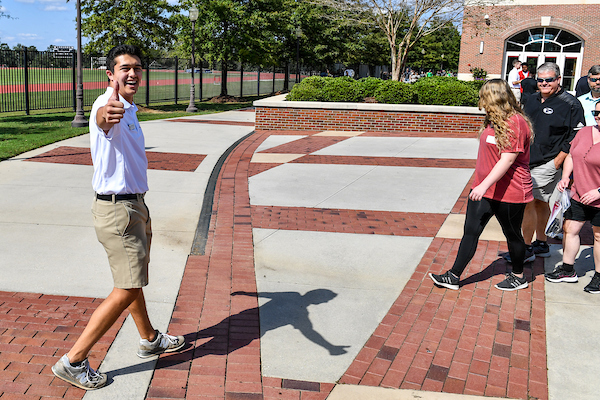 Trojan Ambassador tour guide giving a campus tour on Trojan Day