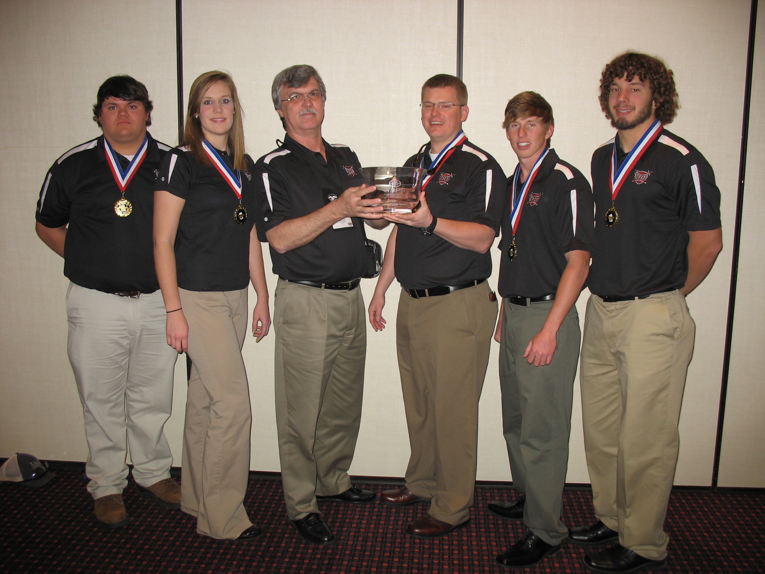 Dr. Griffin with students and trophy won at national geomatics competition