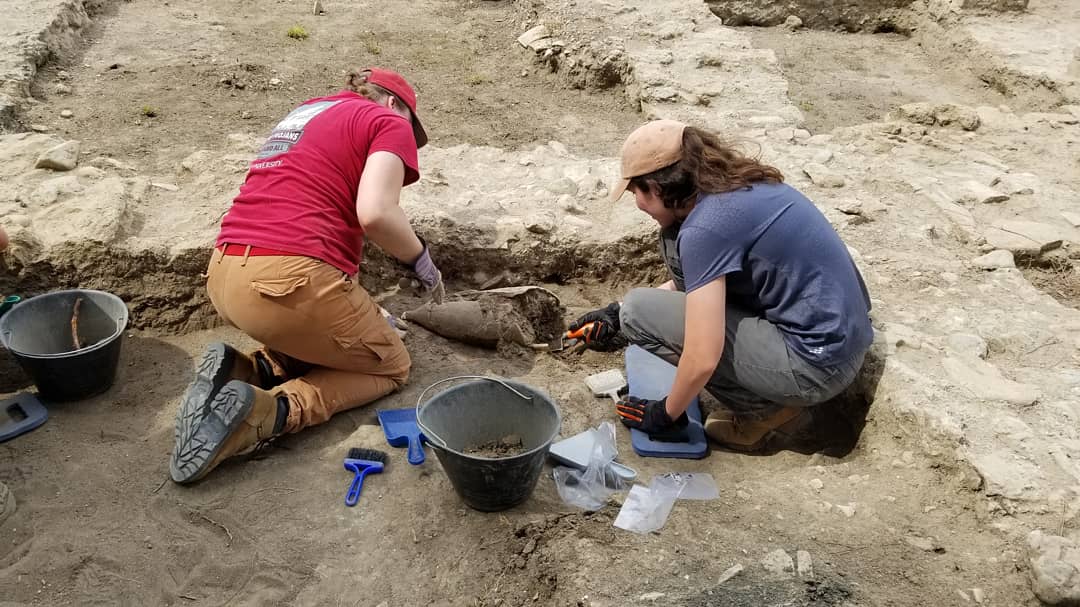 Troy University student Kristen Bird and Italian colleague excavating human remains at the Vada Volaterrana site.