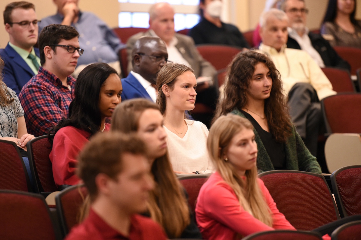 A Group of Students along with Professors attending a Lecture