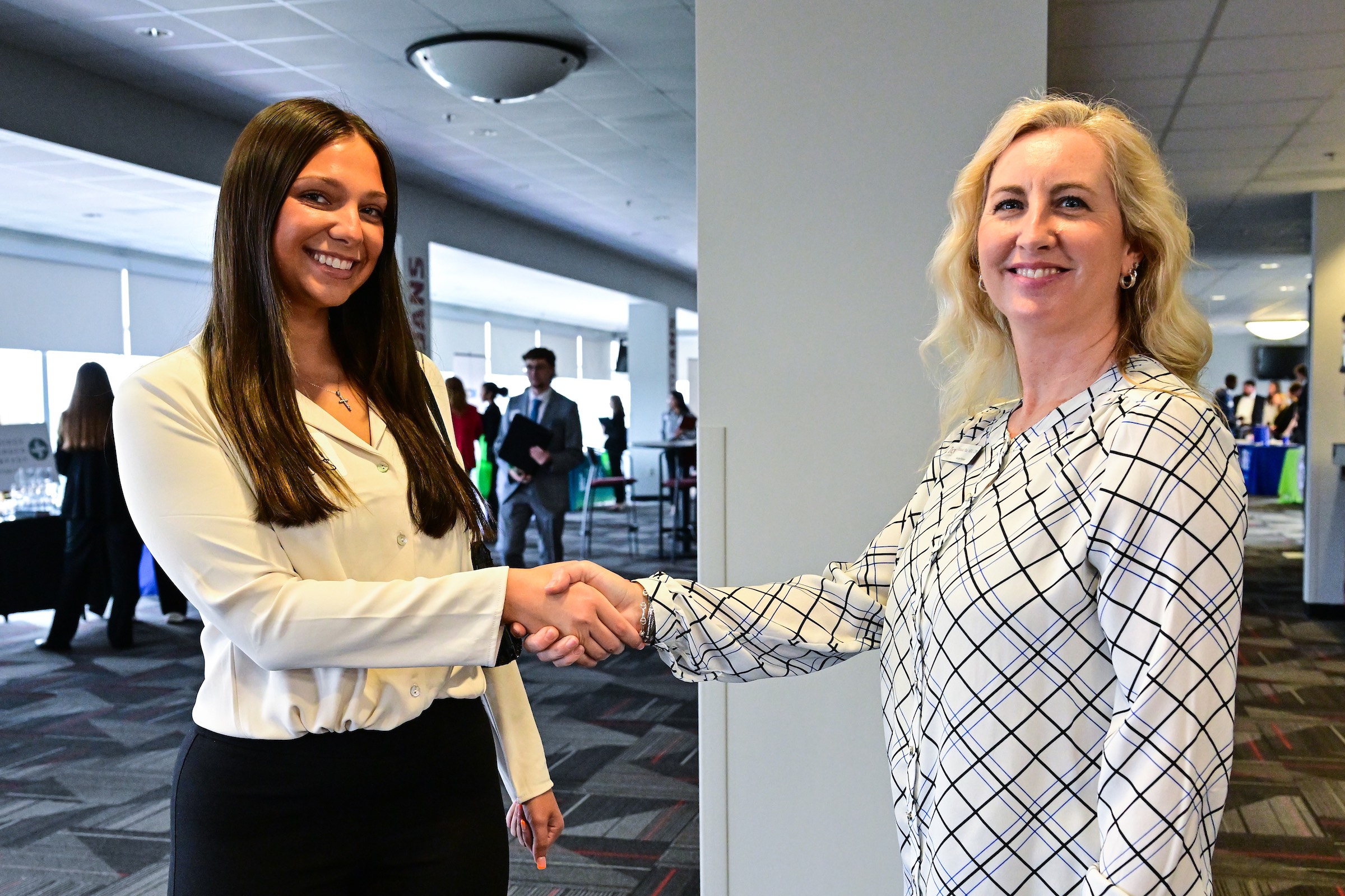 student shaking hands with professor