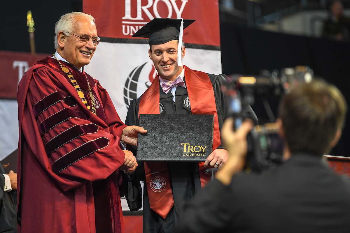 Graduate with Chancellor Hawkins at commencement