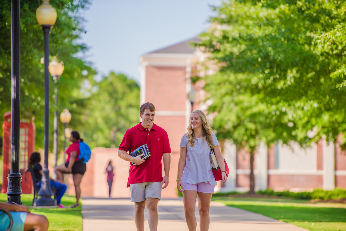 Two students walking on campus