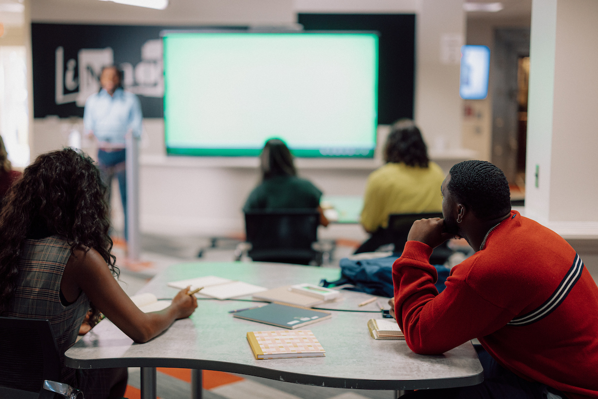 Students listening to a presentation from another student