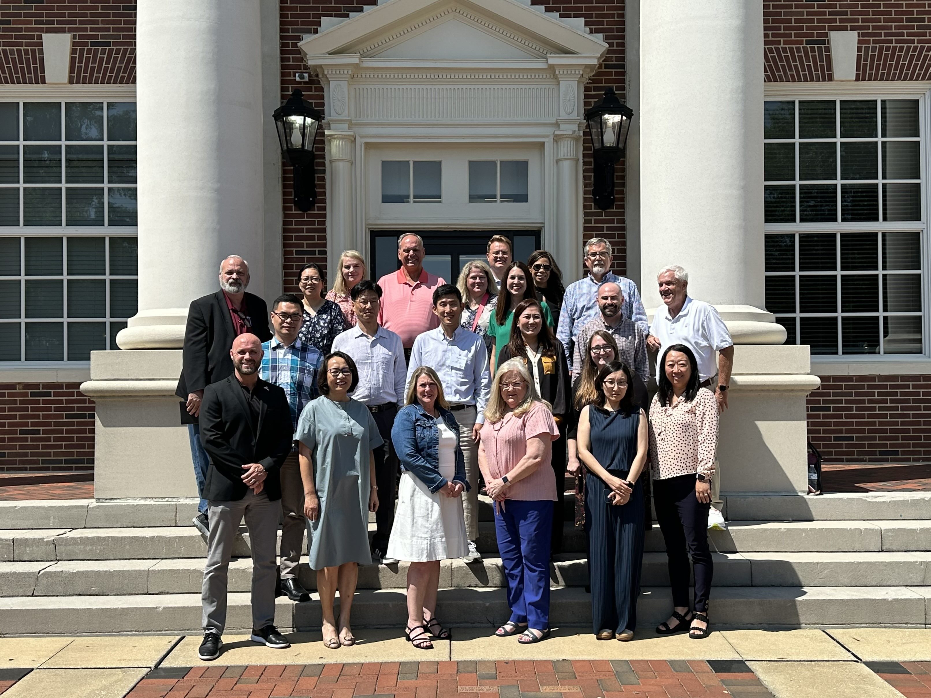 Faculty group photo on the steps of John Robert Lewis Hall.