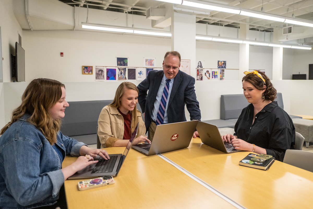 Dean Thrasher with graphic design students in the International Arts Center studio