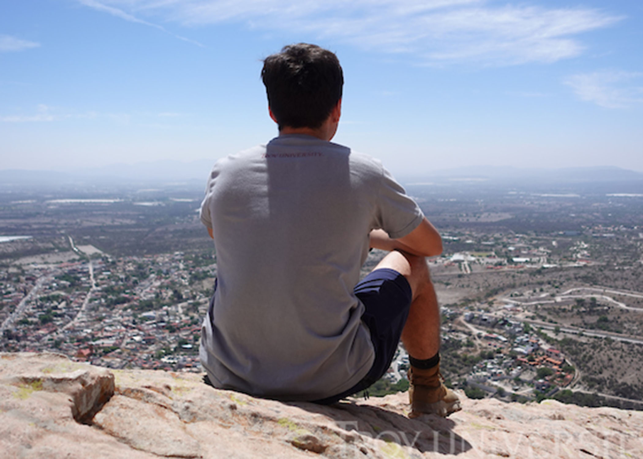 TROY study abroad student sitting on a cliff enjoying the view in Mexico