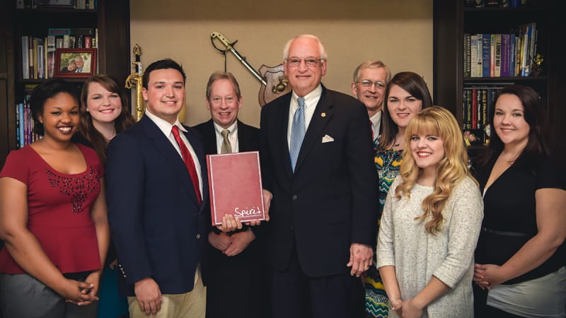 Palladium staff presents Dr. Hawkins with a copy of the Palladium