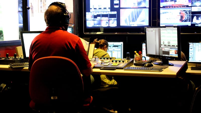 Students work in the TrojanVision control room to produce a 30 minute newscast.