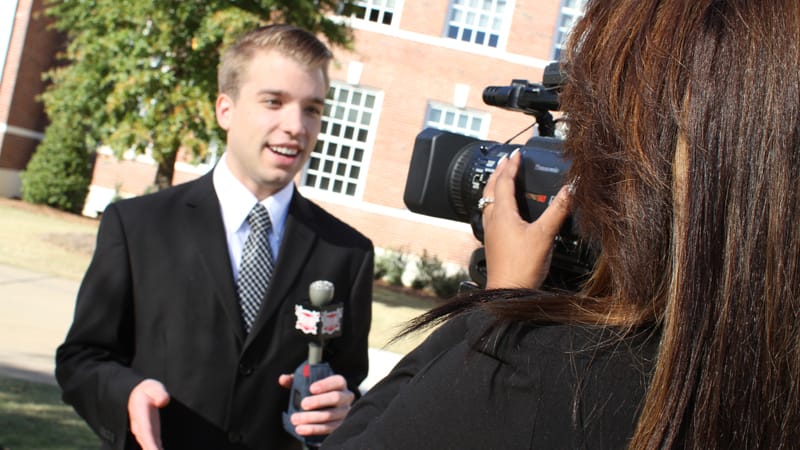 Student reporter Judson Garner records a stand up with the help of a student videographer.