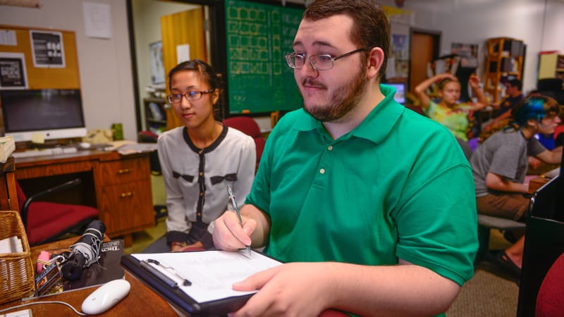 Student reporters, Ngoc Vo and Chase Robinson, work on a story for the Tropolitan