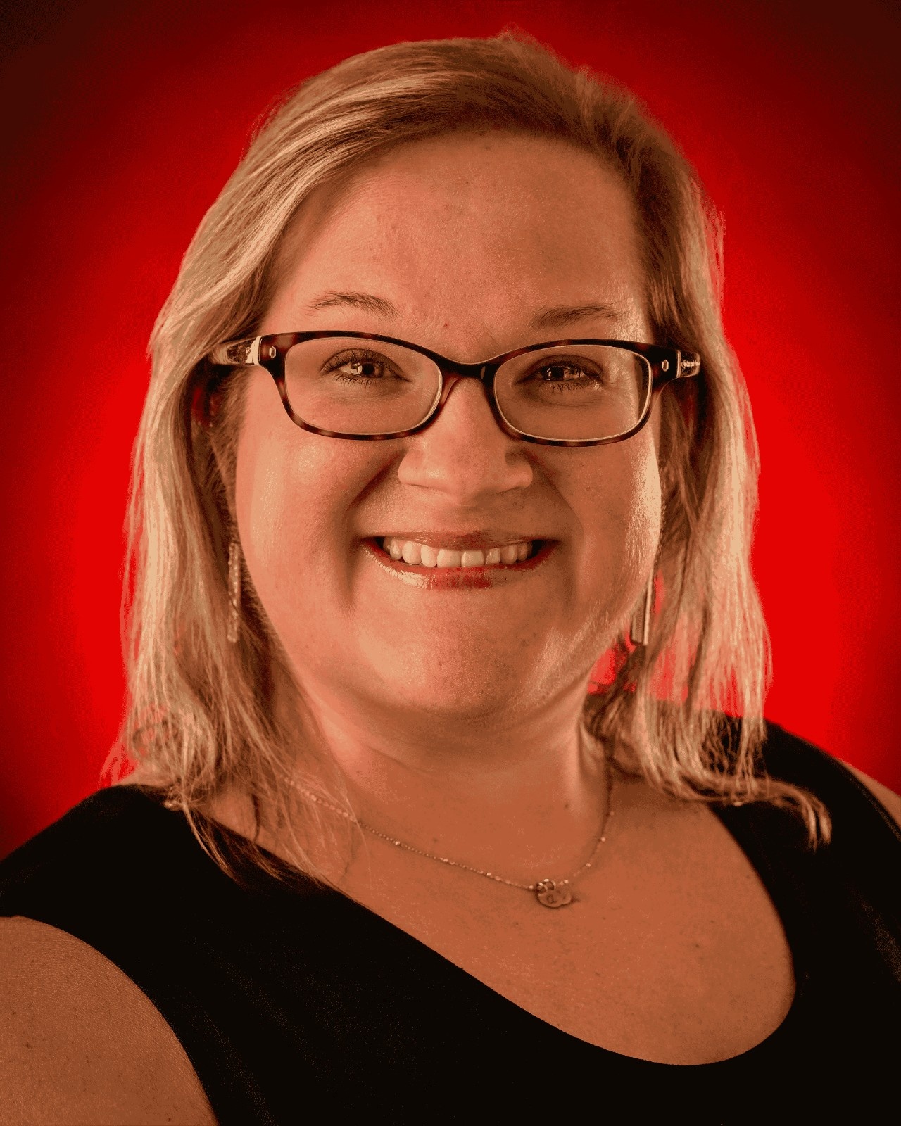 Sally Gomez headshot with a red background