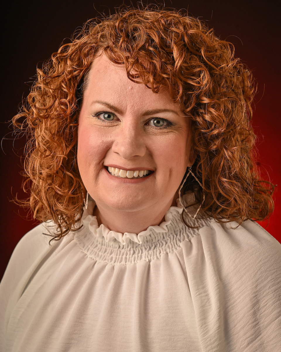 Hope Parrish headshot with a red background.