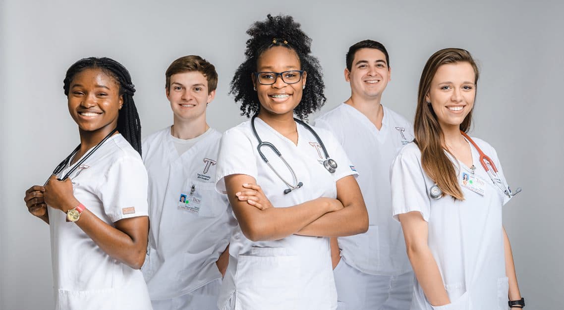 Students in scrubs enrolled in the TROY nursing program.