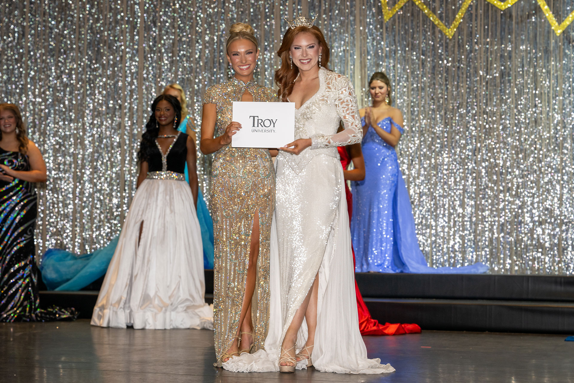 McKinley Murray is the Fitness Winner of Miss Troy 2026. She is receiving the award from Grace Shellhouse, Miss Troy University 2025.