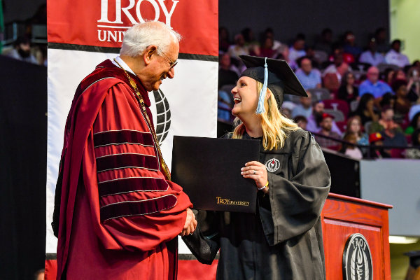 Dr. Hawkins and graduating student at commencement ceremony