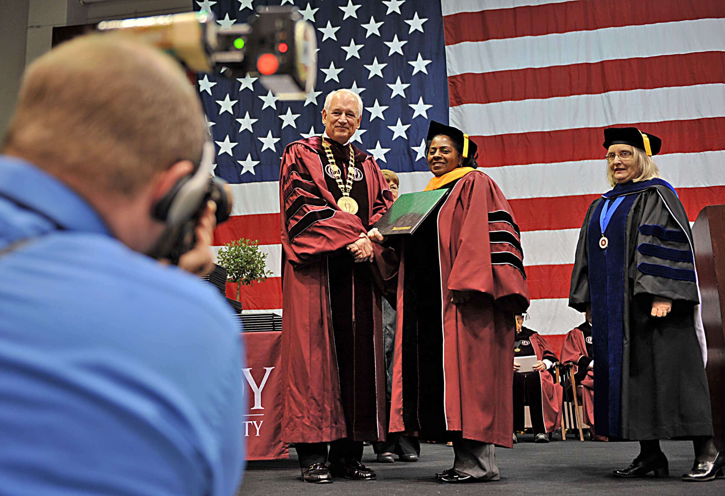 Chancellor Hawkins presents the first-ever doctoral degrees to the first graduates of the Doctorate of Nursing Practice Program in Sartain Hall.