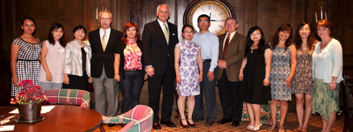 Scholars enjoy a moment with the Chancellor and other staff.