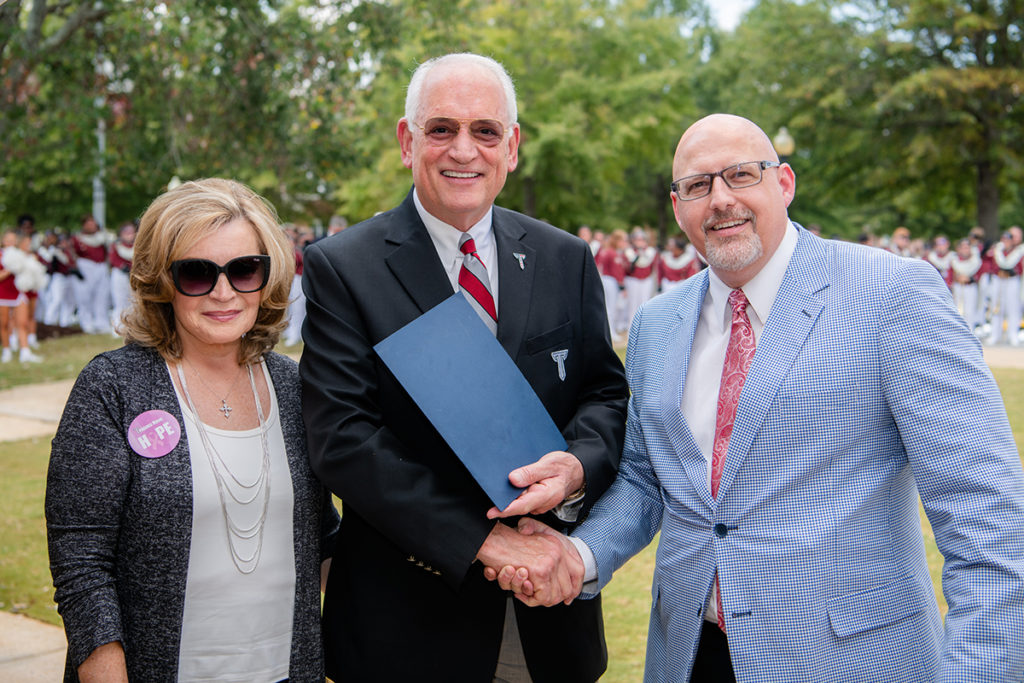 Dr. Dan Puckett, president of TROY’s Faculty Senate, presents Dr. and Mrs. Jack Hawkins, Jr. with a resolution honoring Dr. Hawkins’ 30th year as the University’s Chancellor.