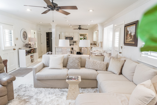 The open floor plan of the Chancellor’s residence is shown from the sectional couch into the kitchen and eat-in dining room. 