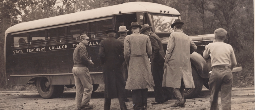 Photo of an old Troy school bus ready to transport students.