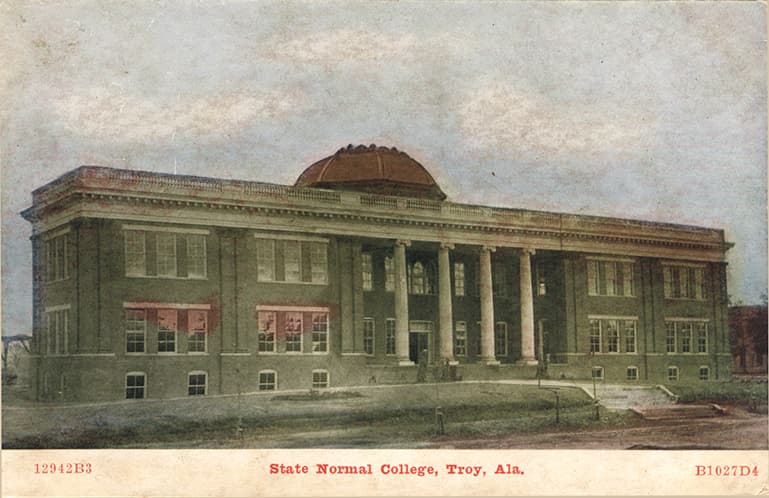 Mostly black and white photograph of the three-story State Normal College building in Troy, Alabama.