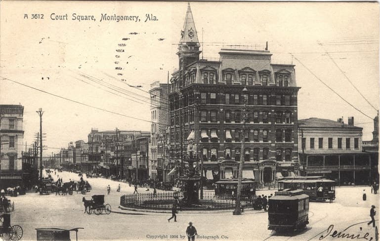 Black and white print showing Court Square Fountain and the multi-story Moses Building in Montgomery, Alabama. Postmarked February 07, 1906.