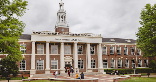 John Robert Lewis Hall Building with students in front of it with the chancellor