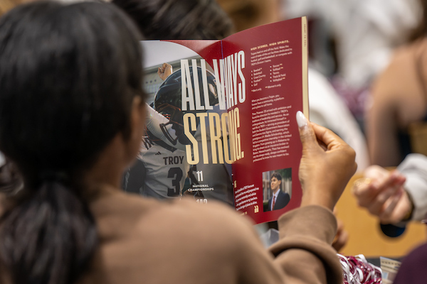 Student viewing the Troy University viewbook