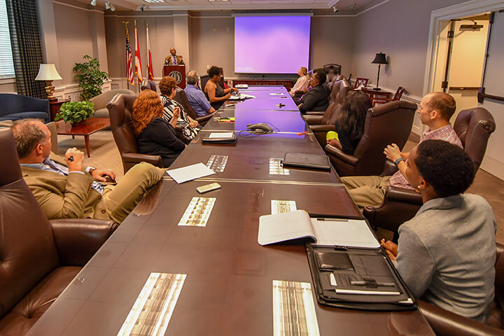 Employees at a conference table.