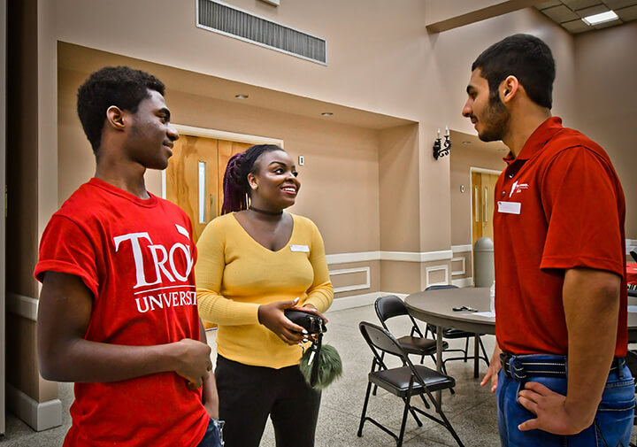 Troy students having a conversation on campus. 