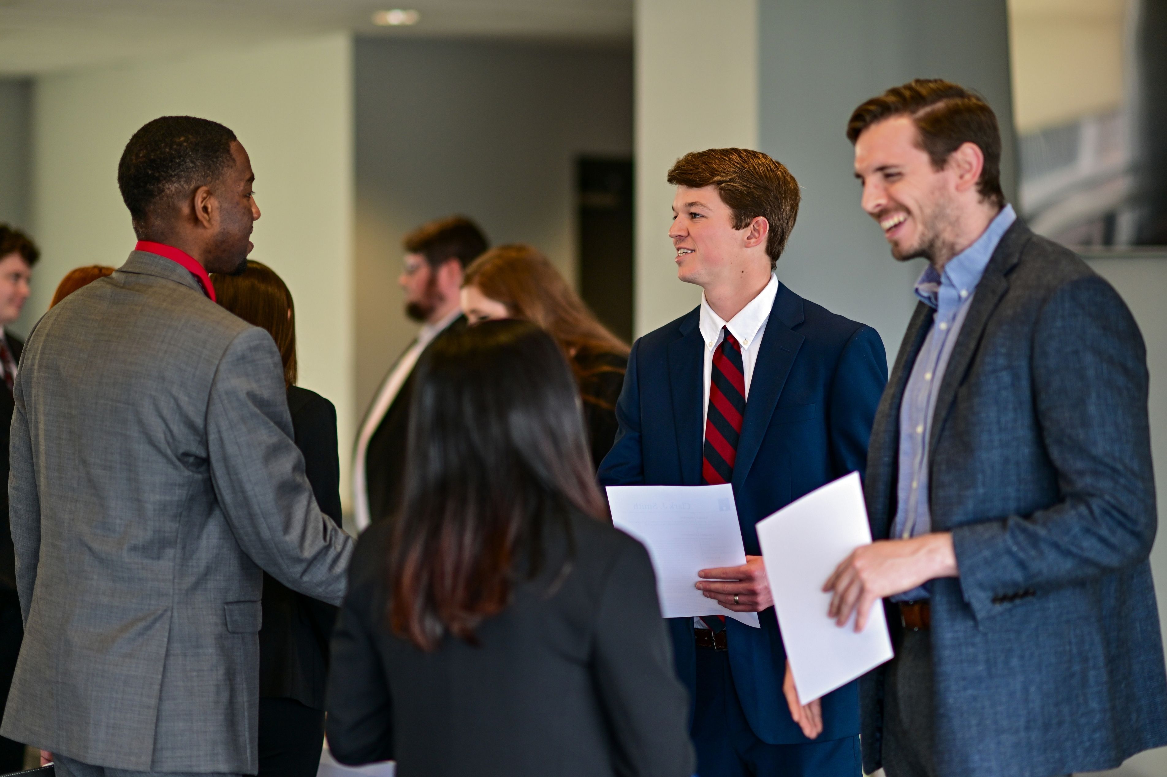 Students meeting with future employers at a career fair.