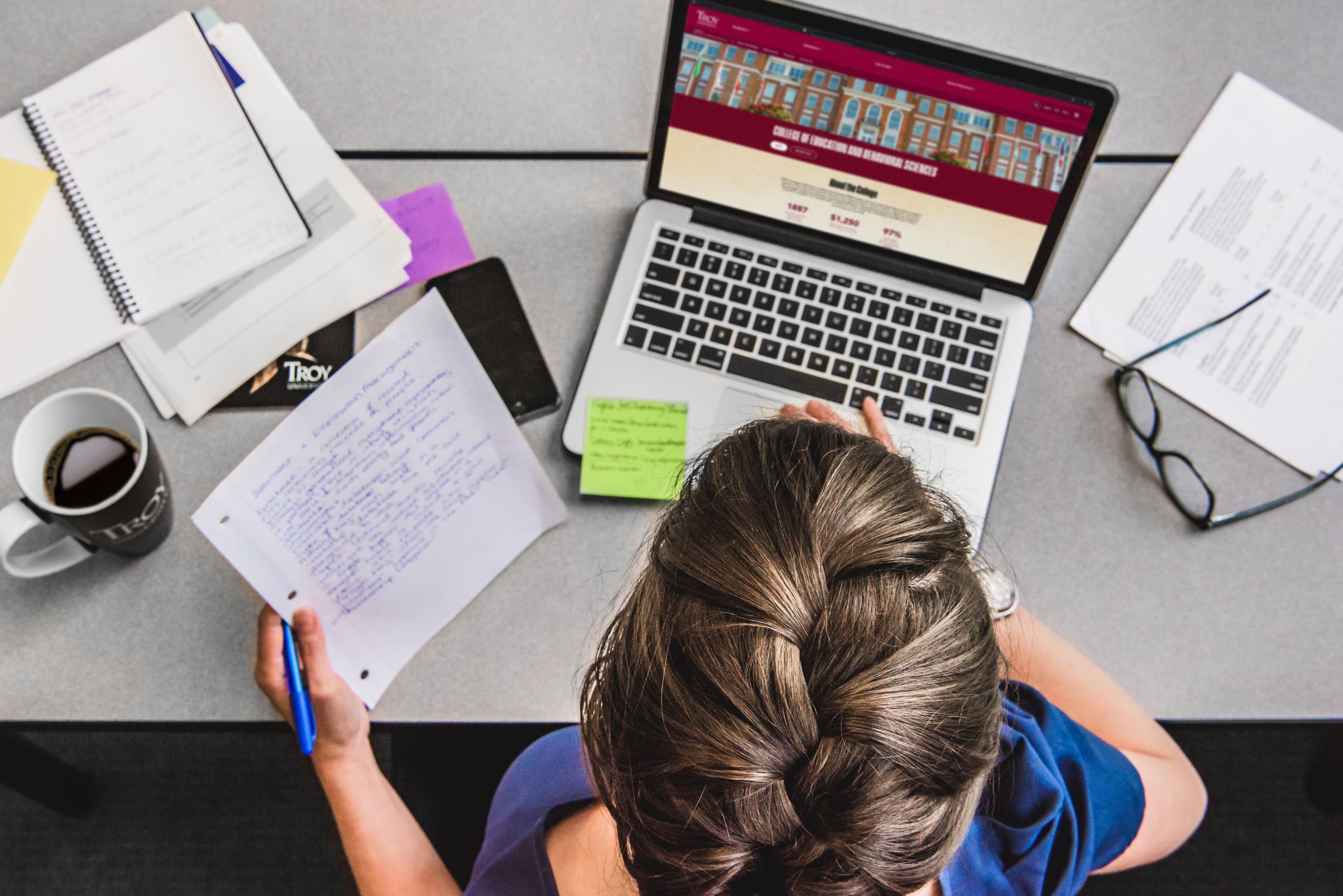 Top view of a student on her computer studying