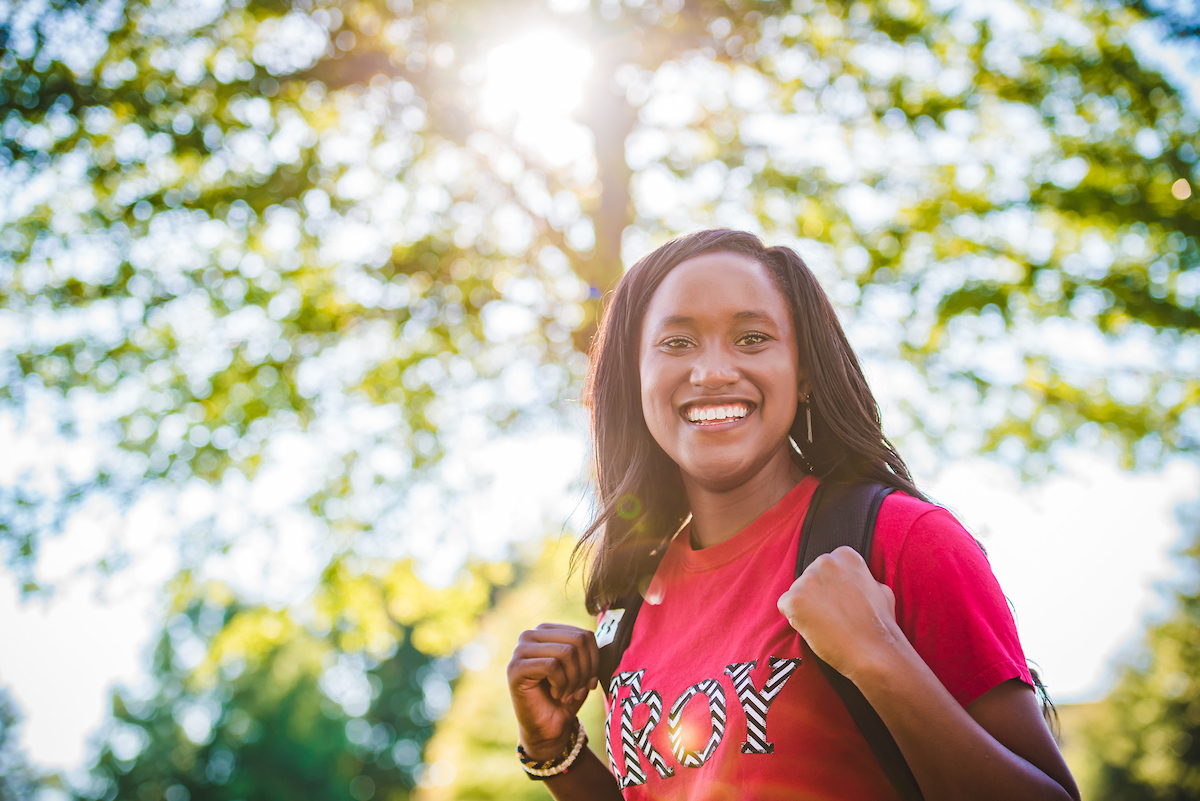 Student smiling on campus.