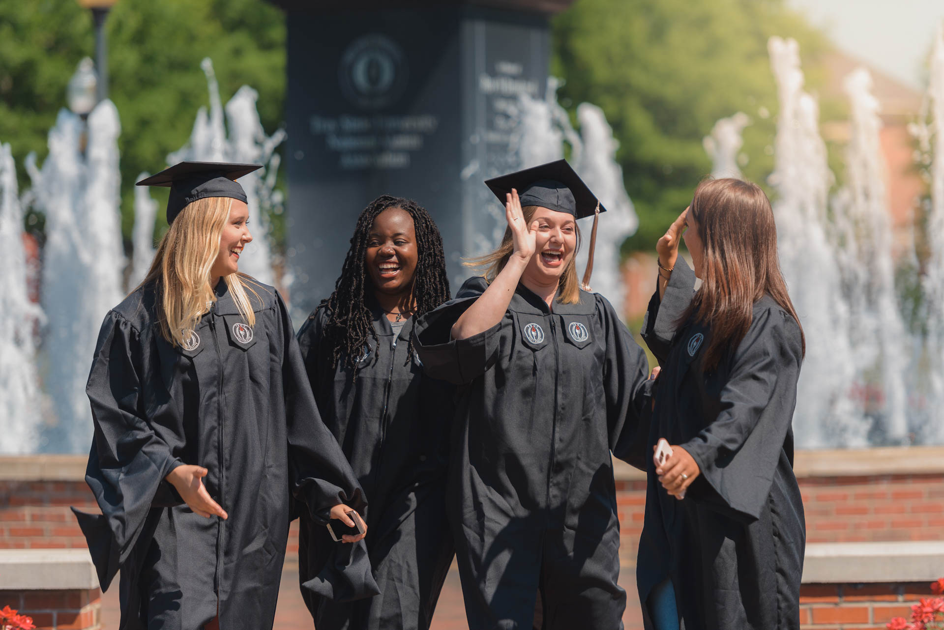 TROY graduates celebrating on the Academic Quad