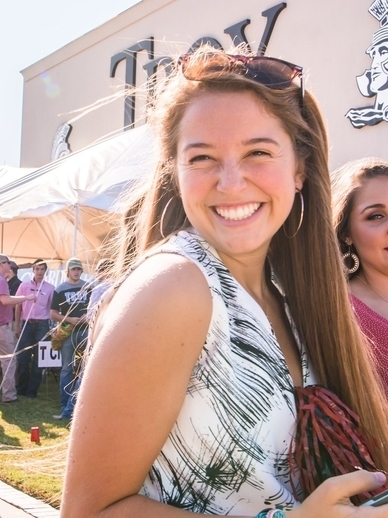 Troy student smiling on game day.