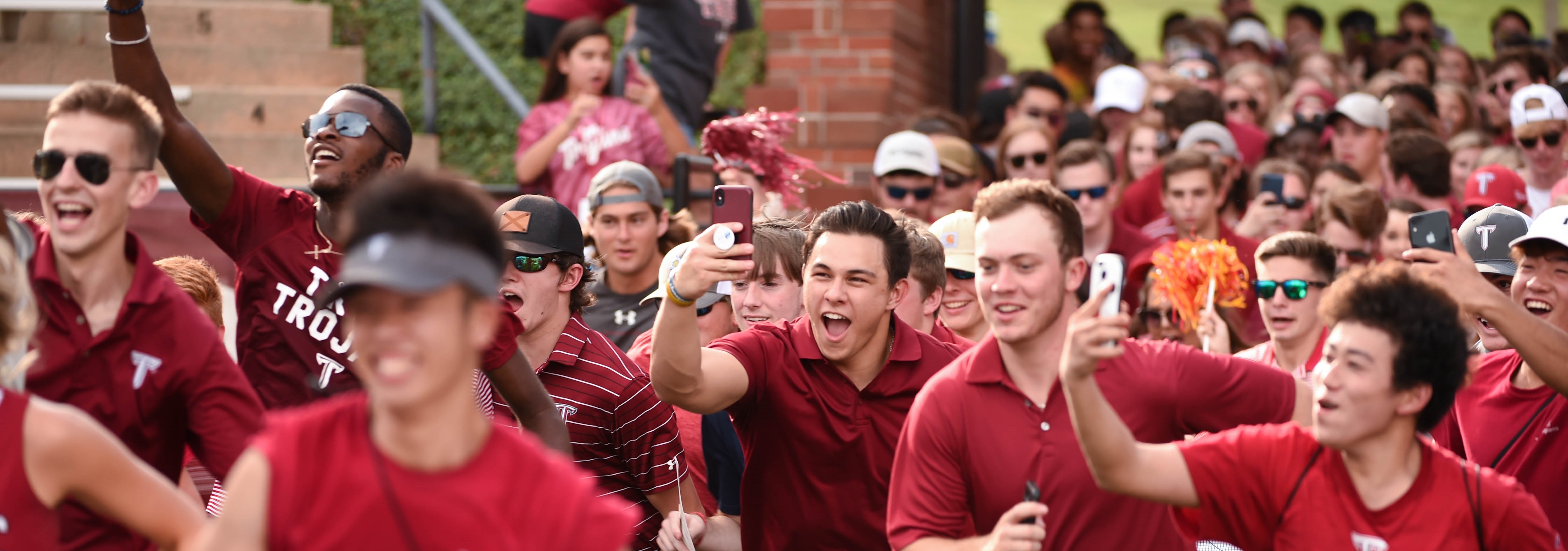 Students running onto the football field during the Freshman Run