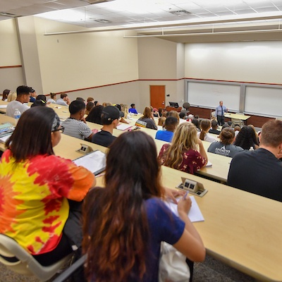 Students sit in a classroom.