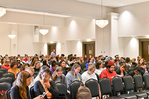 A group of people gathered in a ballroom.