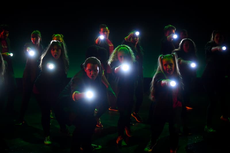 group performers with flashlights