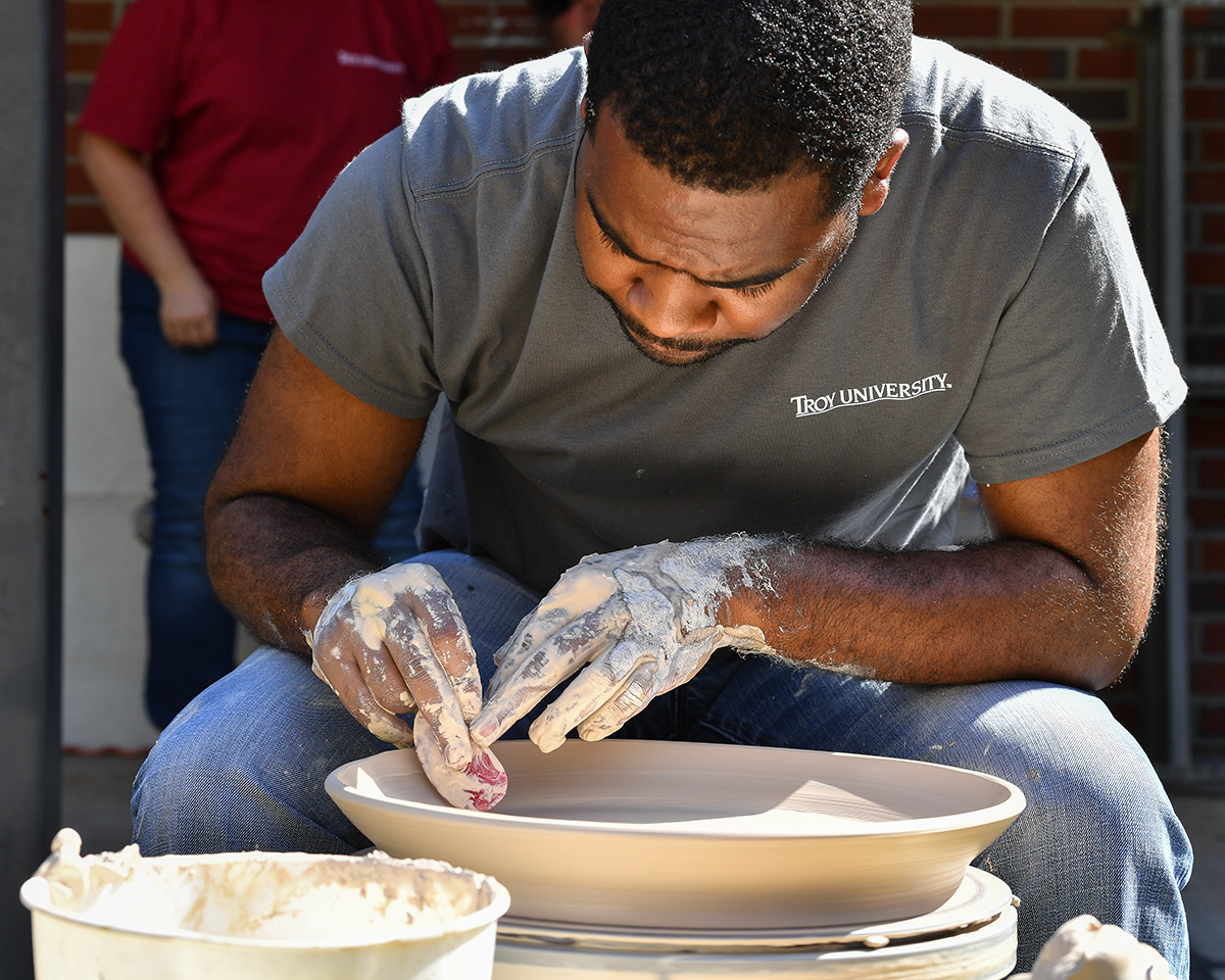 young artist working with pottery