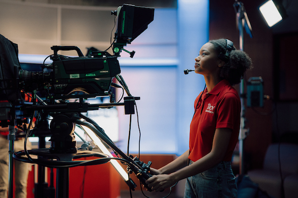 Student using the camera in TrojanVision studio