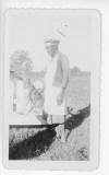 Willadean (Martin) Hall's grandmother, Annie Jane Martin, in backyard of her house 115 Hall St., Abbeville. With dog. Date is late 1930s to early 1940s