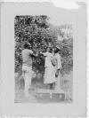 L-R Willie Gene Martin (t-shirt, khakis), unidentified woman in dress and hat, unidentified man in fedora, long-sleeved shirt khakis.